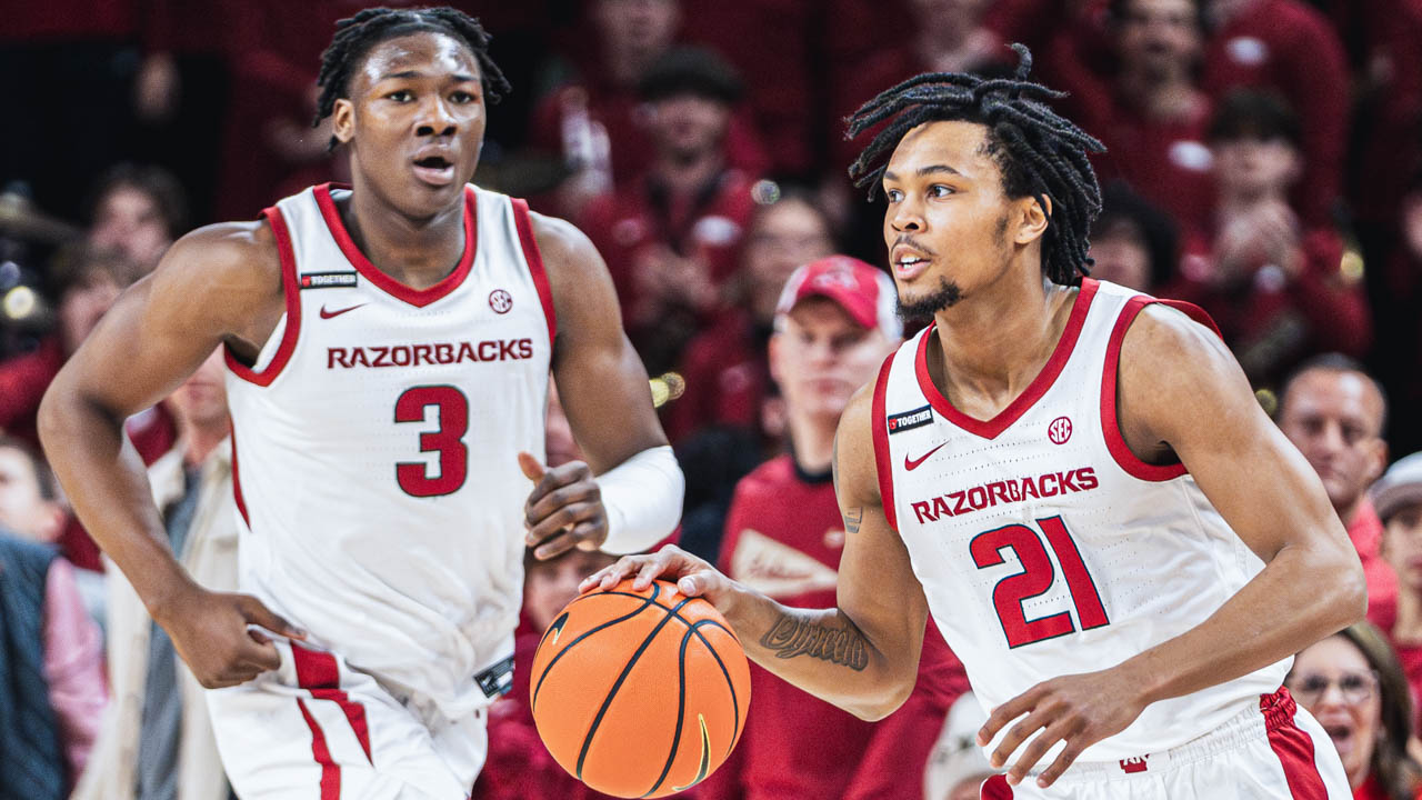 Razorbacks DJ Wagner brings the ball upcourt as teammate Adou Thiero against Florida