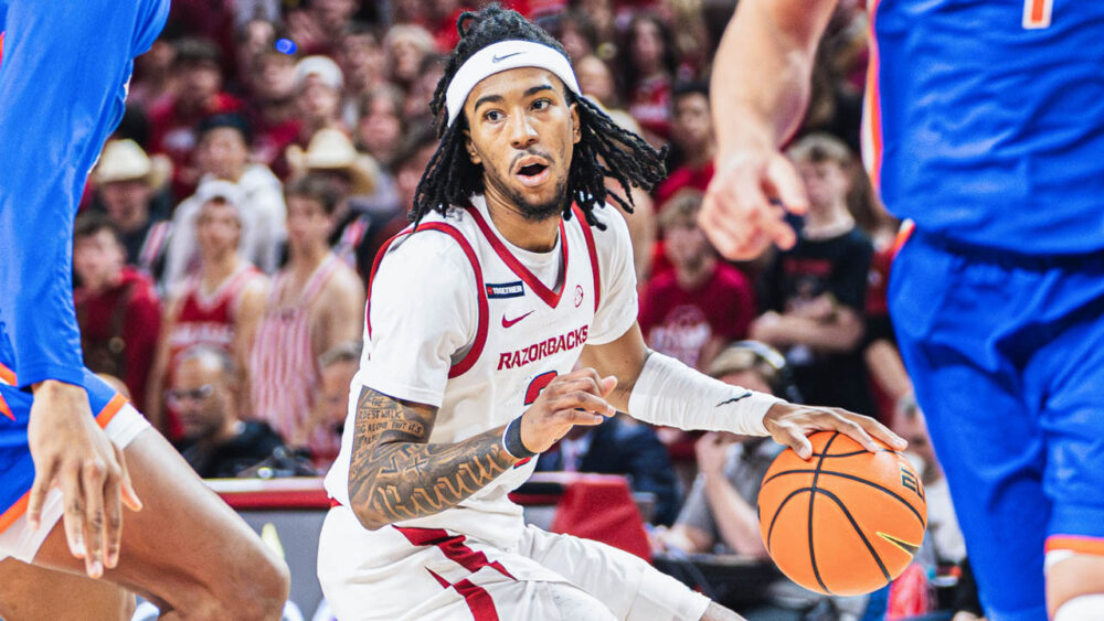 Razorbacks point guard Boogie Fland drives against Florida