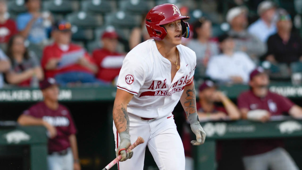 Razorbacks designated hitter Kuhio Aloy heads to first after a hit against Little Rock