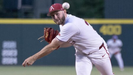 Razorback pitcher Zach Root throws to the plate