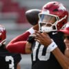 Razorbacks quarterback Taylen Green during spring practice with offensive coordinator Bobby Petrino watching