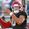 Razorbacks quarterback Taylen Green throwing during drills in spring practice inside Razorback Stadium