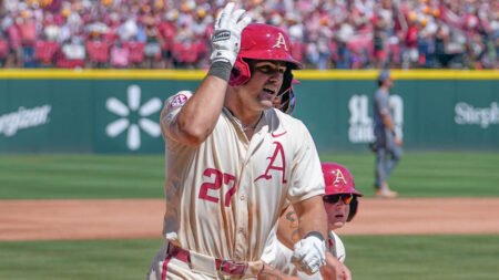 Razorbacks catcher Ryder Helfrick comes home after hitting a home run against Tennessee
