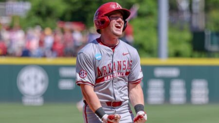 Razorbacks outfielder Logan Maxwell celebrates a grand slam home run as he comes to the plate in the fifth inning against Tennessee