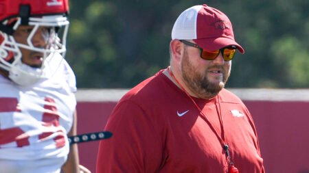 Razorbacks offensive line coach Eric Mateos during spring practice on the outdoor field