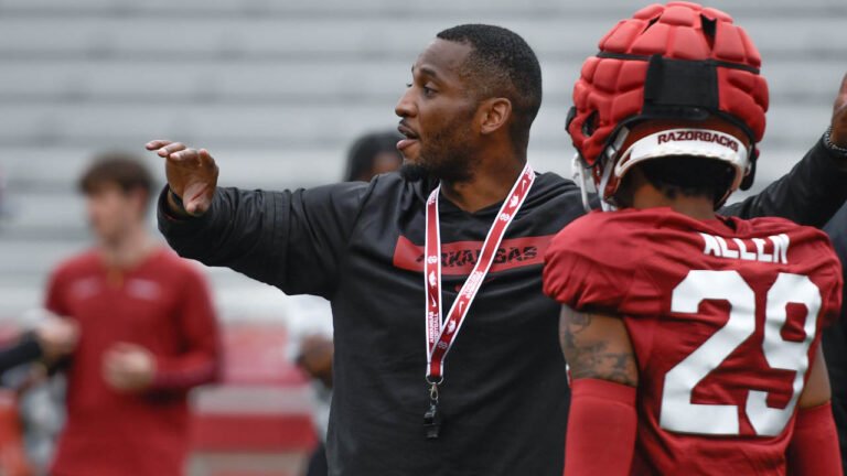 Razorbacks defensive coach Nick Perry on the outdoor practice fields in spring practice