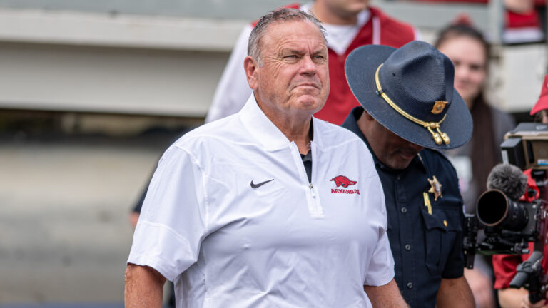 Arkansas Razorbacks coach Sam Pittman walking on the field at War Memorial Stadium