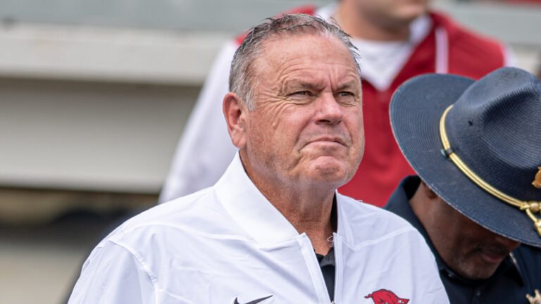 Arkansas Razorbacks coach Sam Pittman walking on the field at War Memorial Stadium