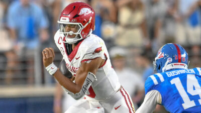 Arkansas Razorbacks quarterback Taylen Green scrambling for yardage against the Ole Miss Rebels