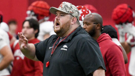 Arkansas Razorbacks offensive line coach Eric Mateos during spring practice drills indoors