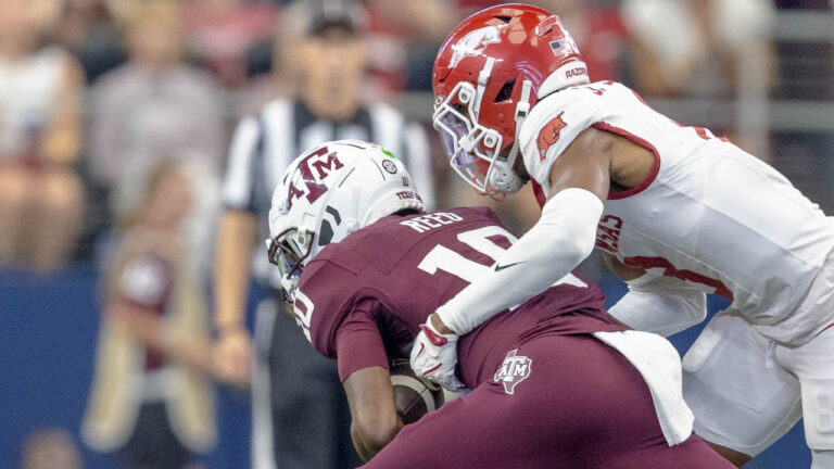 Texas A&M quarterback Marcel Reed is brought down by an Arkansas Razorbacks defender