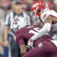 Texas A&M quarterback Marcel Reed is brought down by an Arkansas Razorbacks defender