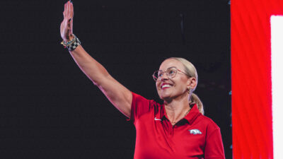 Arkansas Razorbacks women's coach Kelsi Musick waves to the crowd at Bud Walton Arena for the Primetime at the Palace event