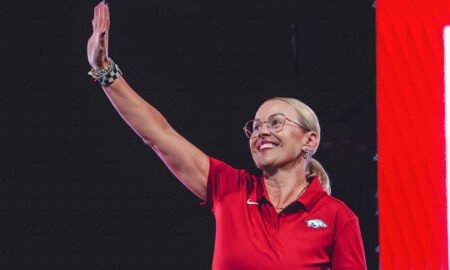 Arkansas Razorbacks women's coach Kelsi Musick waves to the crowd at Bud Walton Arena for the Primetime at the Palace event