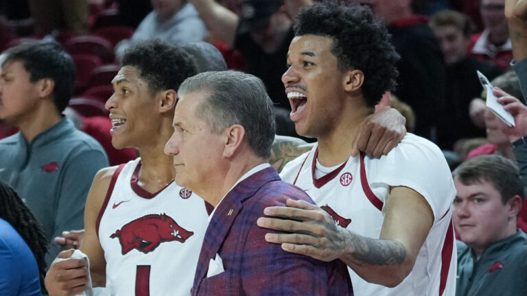 Arkansas Razorbacks coach John Calipari with players Meleek Thomas and Malique Ewin near end of win over the South Carolina Gamecocks