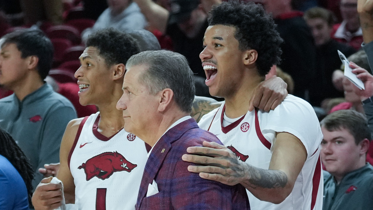 Arkansas Razorbacks coach John Calipari with players Meleek Thomas and Malique Ewin near end of win over the South Carolina Gamecocks