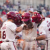 Arkansas players celebrate at home plate during the 2026 SEC Baseball Tournament in Hoover, Ala. | Arkansas Communications