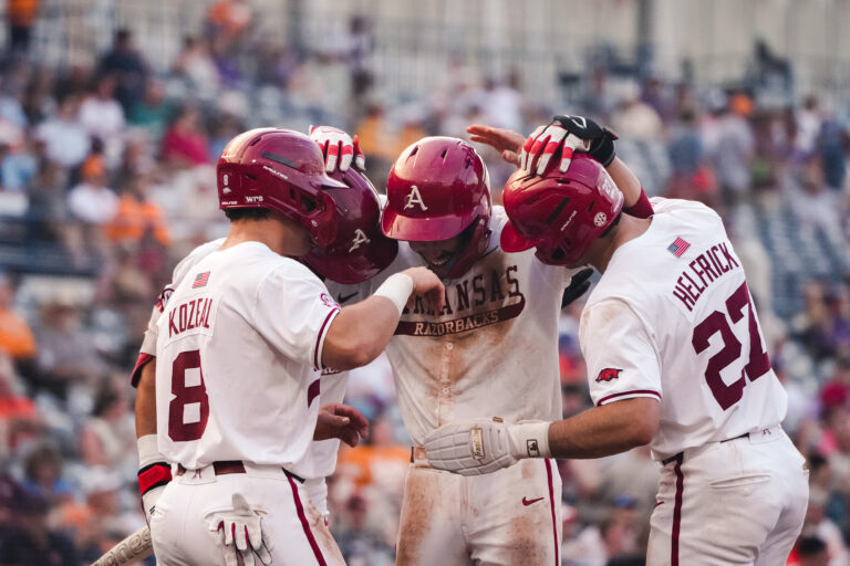 Arkansas players celebrate at home plate during the 2026 SEC Baseball Tournament in Hoover, Ala. | Arkansas Communications