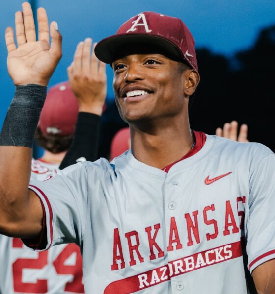 Arkansas junior outfielder Damian Ruiz high fives teammates after the Razorbacks' 8-1 win against Texas in a SEC Tournament game. | SEC/X