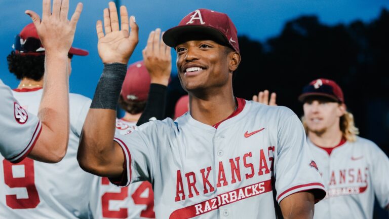Arkansas junior outfielder Damian Ruiz high fives teammates after the Razorbacks' 8-1 win against Texas in a SEC Tournament game. | SEC/X