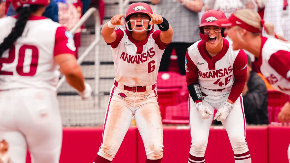 Arkansas sophomore Ella McDowell and senior Kailey Wyckoff cheer as Tianna Bell comes home after her home in a NCAA Super Regional game against Duke. | Arkansas Communications