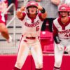 Arkansas sophomore Ella McDowell and senior Kailey Wyckoff cheer as Tianna Bell comes home after her home in a NCAA Super Regional game against Duke. | Arkansas Communications
