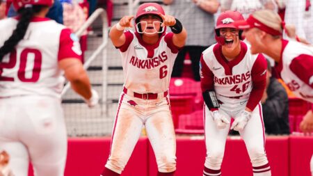 Arkansas sophomore Ella McDowell and senior Kailey Wyckoff cheer as Tianna Bell comes home after her home in a NCAA Super Regional game against Duke. | Arkansas Communications