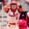 Arkansas sophomore Ella McDowell and senior Kailey Wyckoff cheer as Tianna Bell comes home after her home in a NCAA Super Regional game against Duke. | Arkansas Communications