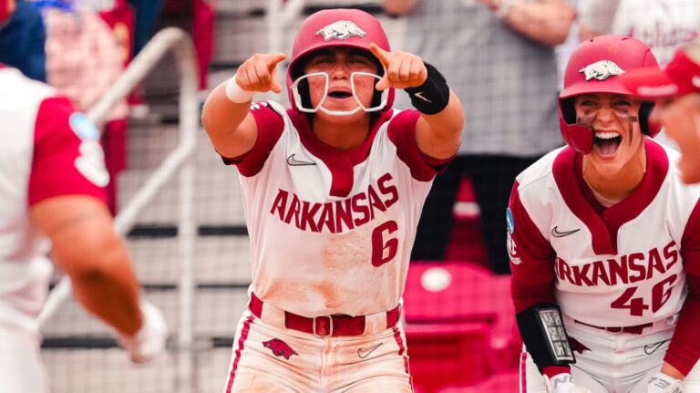 Arkansas sophomore Ella McDowell and senior Kailey Wyckoff cheer as Tianna Bell comes home after her home in a NCAA Super Regional game against Duke. | Arkansas Communications