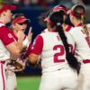 Arkansas third baseman Ella McDowell breaks a huddle in extra innings of a Women's College World Series game against Nebraska. | Arkansas Communications
