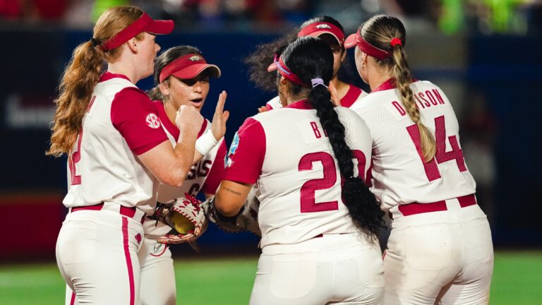 Arkansas third baseman Ella McDowell breaks a huddle in extra innings of a Women's College World Series game against Nebraska. | Arkansas Communications