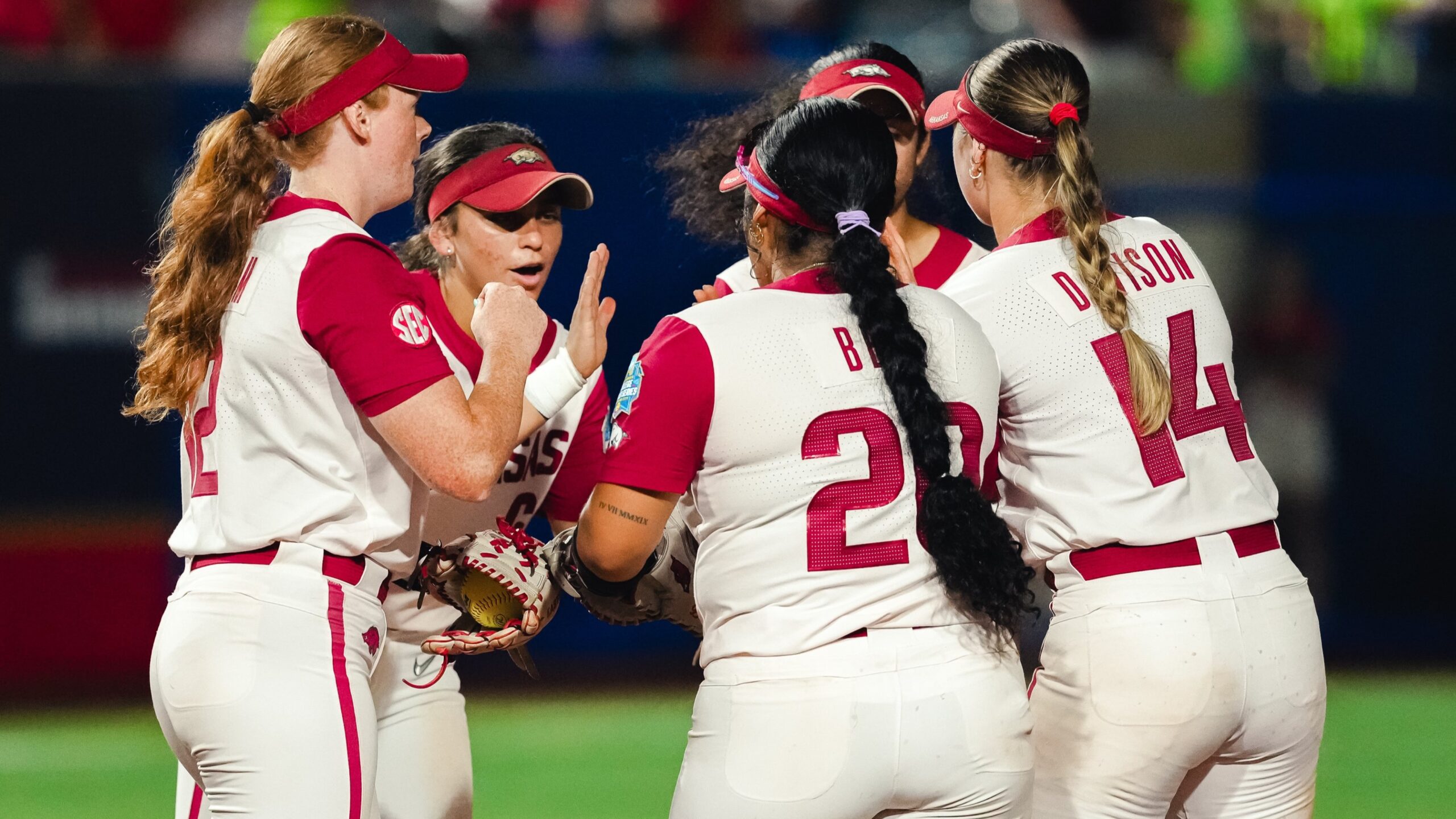 Arkansas third baseman Ella McDowell breaks a huddle in extra innings of a Women's College World Series game against Nebraska. | Arkansas Communications