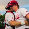 Arkansas relief pitcher Ethan McElvain exchanges a quick hug with catcher Ryder Helfrick after a 9-5 win against Missouri State in a NCAA Regional game. | Arkansas Communications