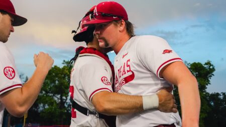 Arkansas relief pitcher Ethan McElvain exchanges a quick hug with catcher Ryder Helfrick after a 9-5 win against Missouri State in a NCAA Regional game. | Arkansas Communications