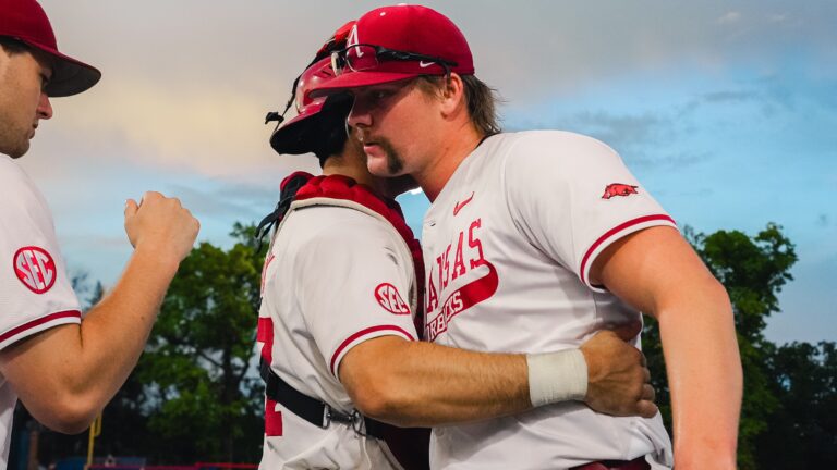 Arkansas relief pitcher Ethan McElvain exchanges a quick hug with catcher Ryder Helfrick after a 9-5 win against Missouri State in a NCAA Regional game. | Arkansas Communications
