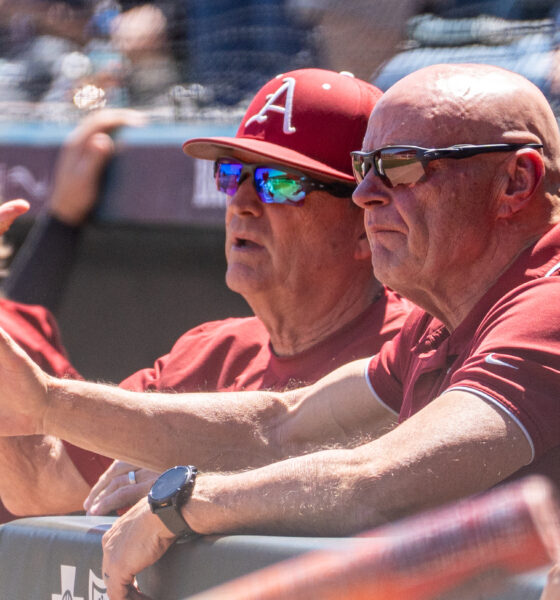 Arkansas baseball coaches discuss strategy from the dugout of a SEC game against Ole Miss in Fayetteville. | Nilsen Roman-allHogs Images