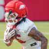 Sutton Smith runs during a Razorback fall camp practice.