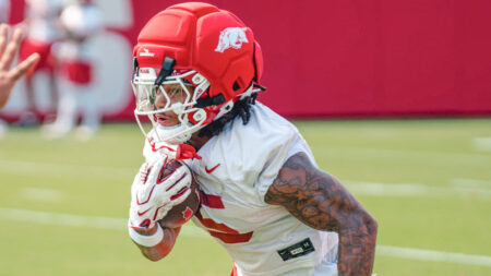 Sutton Smith runs during a Razorback fall camp practice.