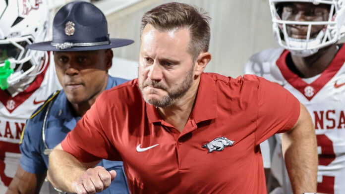 Arkansas Razorbacks coach Ryan Silverfield leads team out for game against the Utah Utes