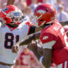 Arkansas Razorbacks quarterback AJ Hill delivers a pass while under pressure from a Georgia Bulldogs rusher in a game at Razorback Stadium