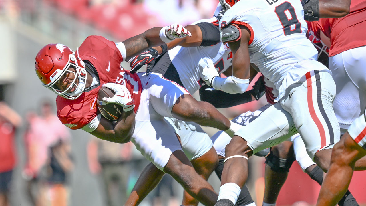 Arkansas Razorbacks running back Cam Settles is brought down during game against the Georgia Bulldogs at Razorback Stadium