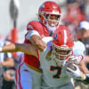 Arkansas Razorbacks defensive back Christian Harrison trying to bring down Georgia Bulldogs tight end Lawson Luckie in game at Razorback Stadium