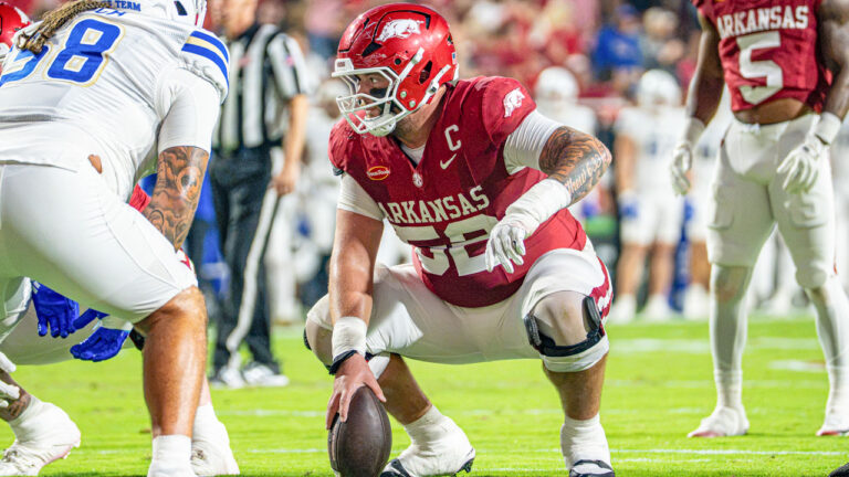 Arkansas Razorbacks center Caden Kitler over the ball during game with Tulsa at Razorback Stadium