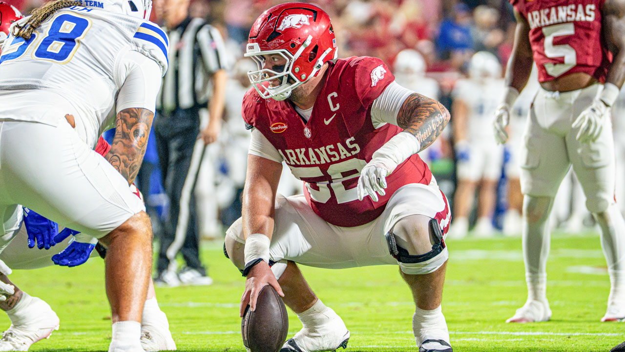 Arkansas Razorbacks center Caden Kitler over the ball during game with Tulsa at Razorback Stadium
