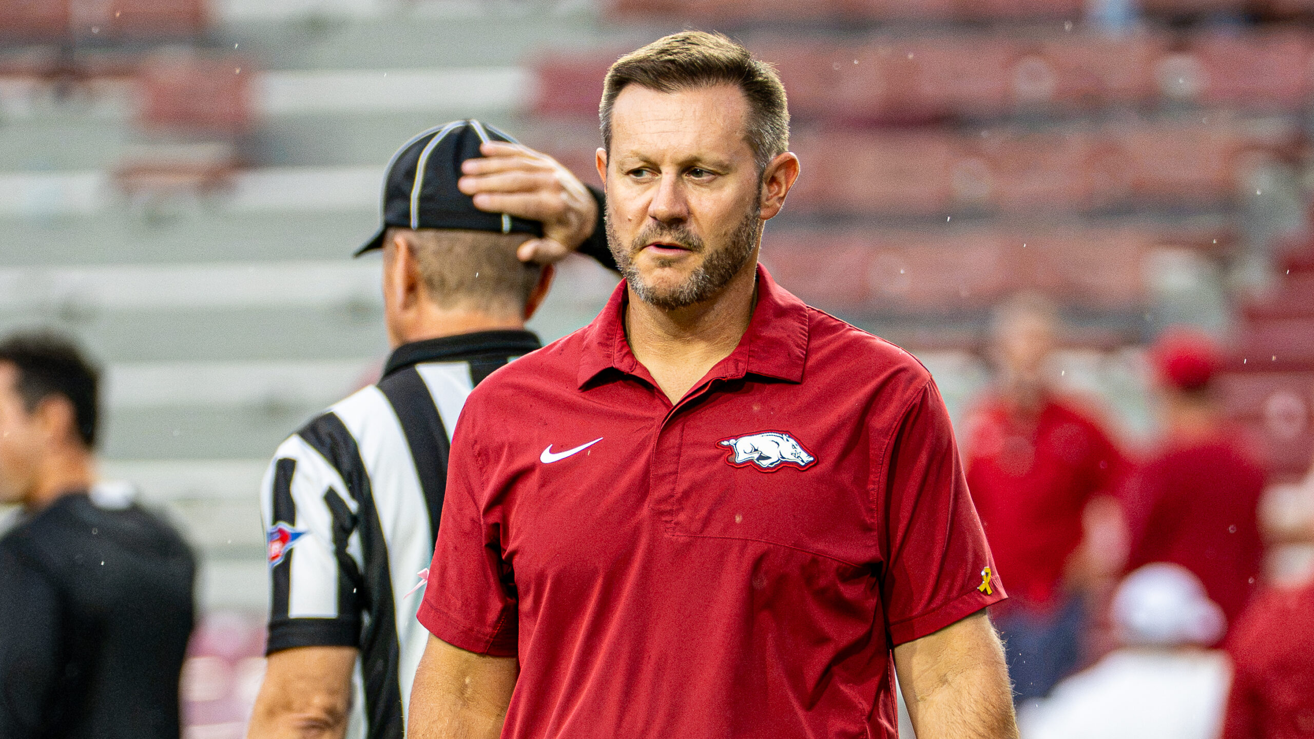 Arkansas Razorbacks coach Ryan Silverfield on the field during warmups before game with the Tulsa Golden Hurricane at Razorback Stadium