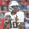 Texas A&M Aggies quarterbck to Marcel Reed drops back to pass in.a game against the Arkansas Razorbacks at Razorback Stadium