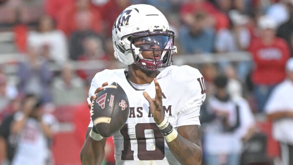 Texas A&M Aggies quarterbck to Marcel Reed drops back to pass in.a game against the Arkansas Razorbacks at Razorback Stadium