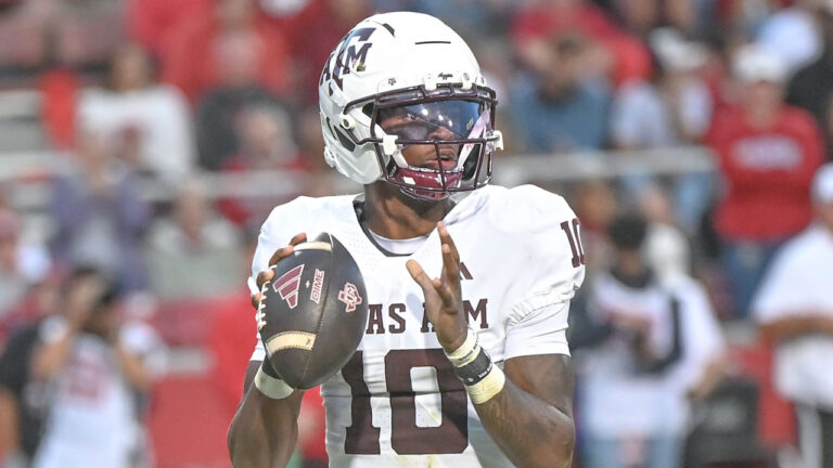 Texas A&M Aggies quarterbck to Marcel Reed drops back to pass in.a game against the Arkansas Razorbacks at Razorback Stadium