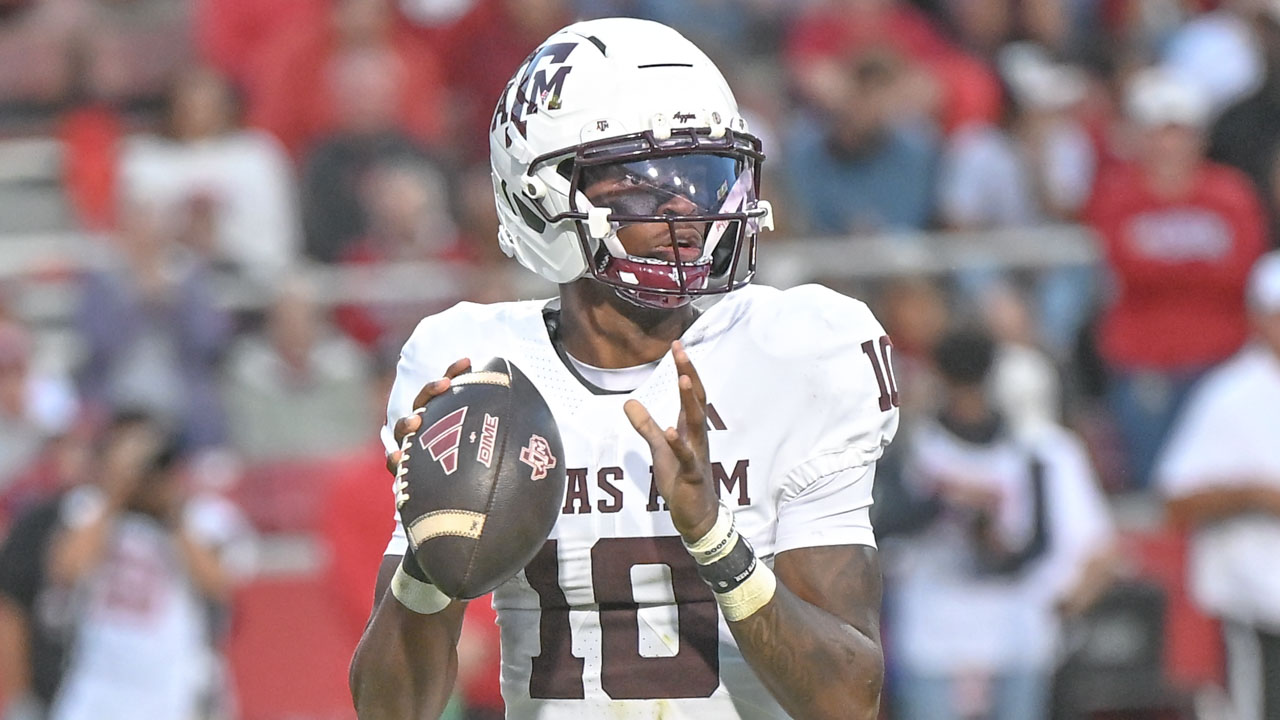 Texas A&M Aggies quarterbck to Marcel Reed drops back to pass in.a game against the Arkansas Razorbacks at Razorback Stadium
