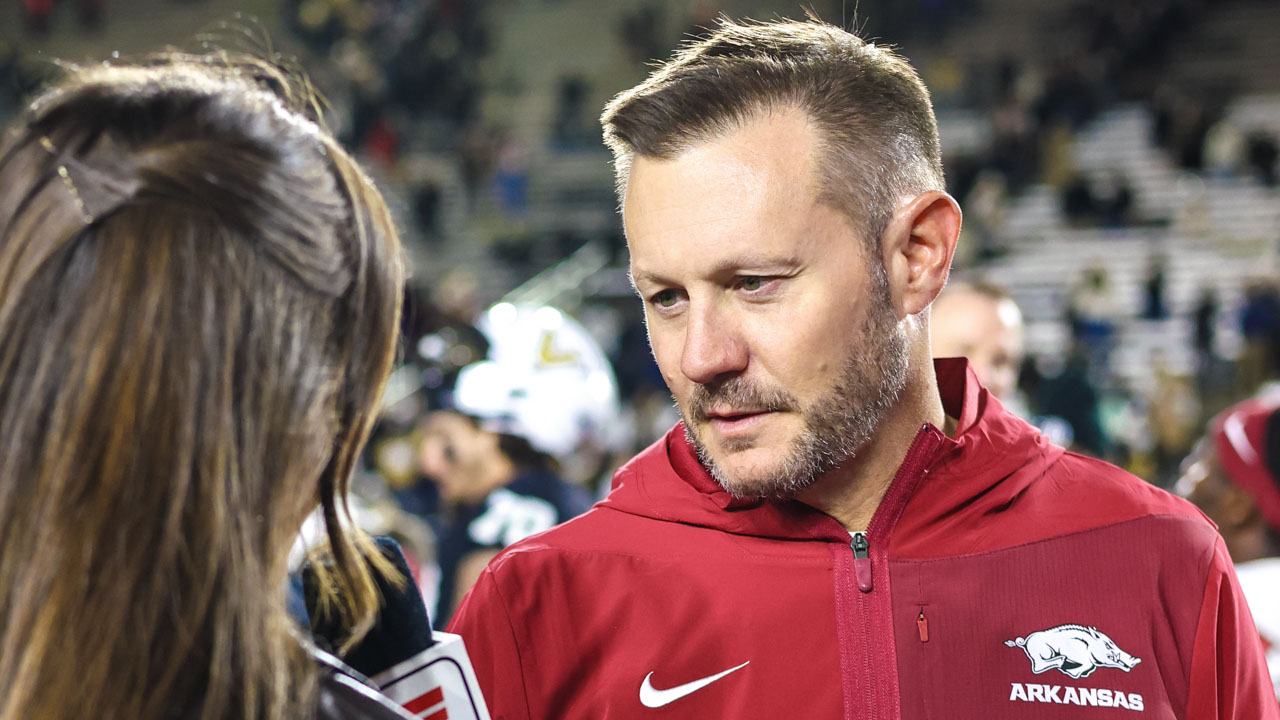 Arkansas Razorbacks coach Ryan Silverfield with ESPN reporter after 31-21 win over the Vanderbilt Commodores